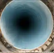 The same sewer line after CIPP relining - a seamless epoxy pipe cured inside the old one, smooth walls and full flow restored